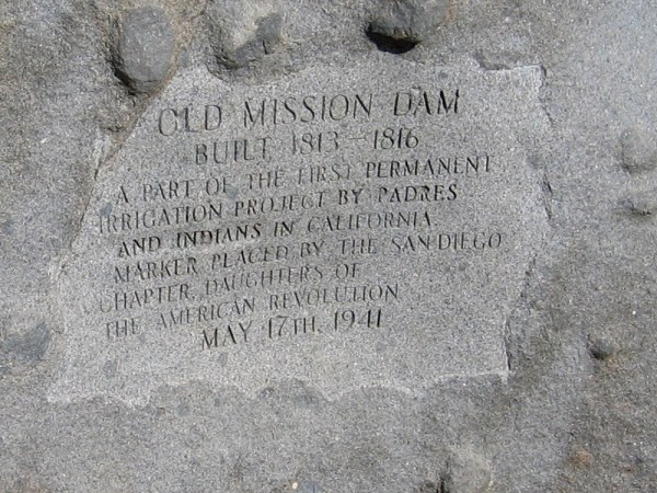 Inscription in a boulder dated 1941, by the Daughters of the American Revolution. OLD MISSION DAM. Built 1813-1816. A part of the first permanent irrigation project by Padres and Indians in California.