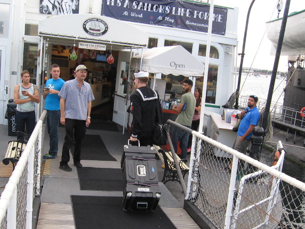 A member of the Navy Band enters the Berkeley steam ferry for a special Saturday evening event at the Maritime Museum.