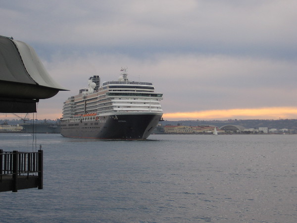 A cruise ship slowly turns, preparing to depart San Diego.