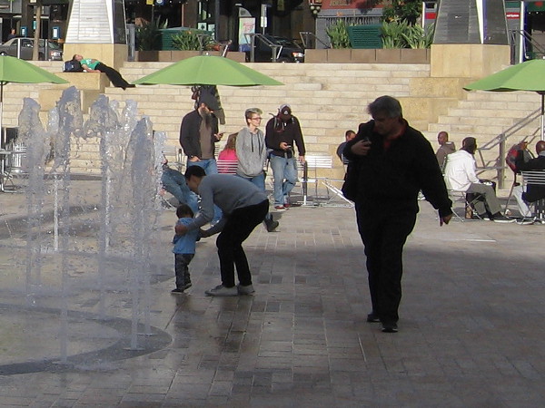But there is also hope, and the potential for joy. A child is shown the dancing fountain at the center of Horton Plaza Park.