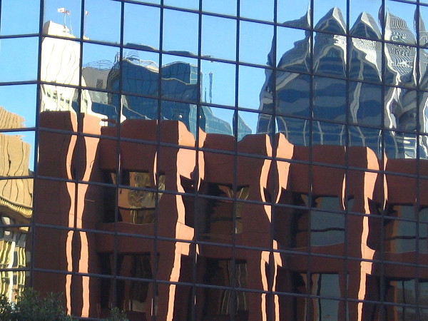 Unusual geometry caused by multiple reflections seen from street level.