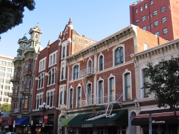 A faded sign is painted high on the 1888 Nesmith-Greely Building on Fifth Avenue. It is just visible from the street.