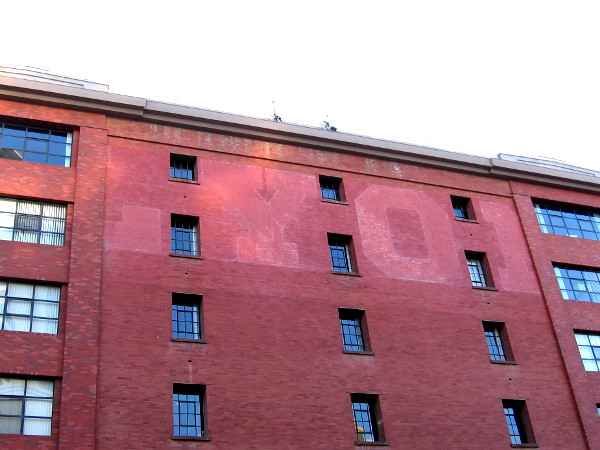 The faded word LYON on a building at the corner of K Street and Fourth Avenue.