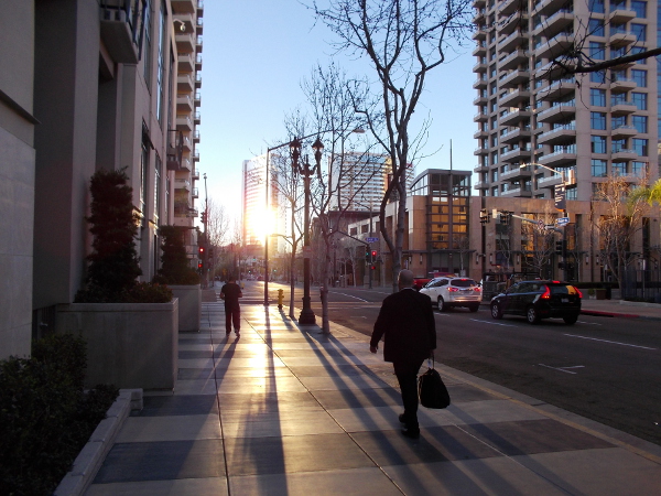 A businessman walks to work in downtown San Diego.