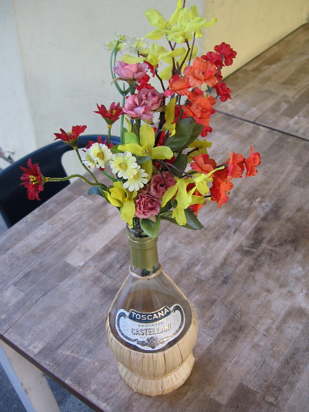 A beautiful bouquet of flowers at an outdoor Little Italy cafe.
