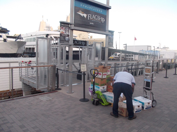 Unloading boxes of produce at the Flagship dock near Broadway Pier.
