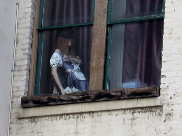 A mannequin high in a window makes one do a double take as one walks down Sixth Avenue through San Diego's Gaslamp.