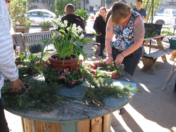 Someone makes a wreath the week before Christmas during a special SMARTS Farm holiday event.