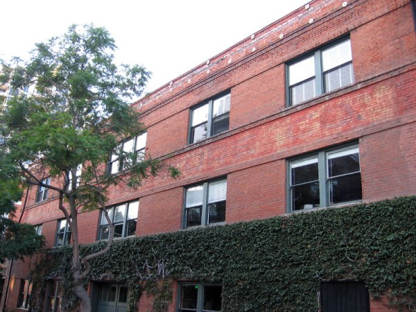 Old brick building at Seventh Avenue and G Street has words so obliterated I can't decipher anything.