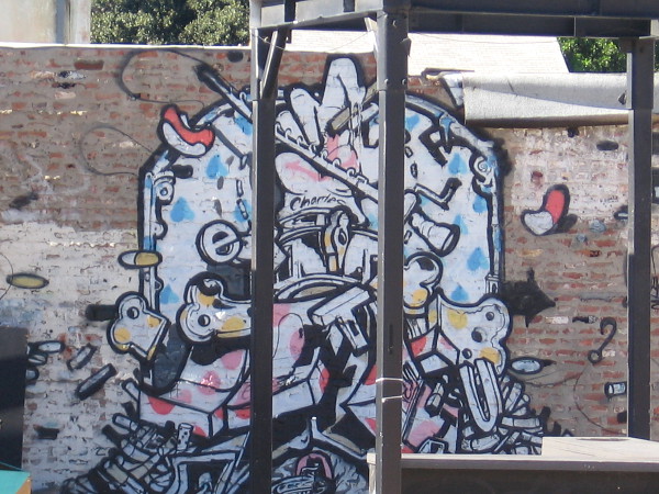 A very cool abstract jumble of street art on a brick wall.