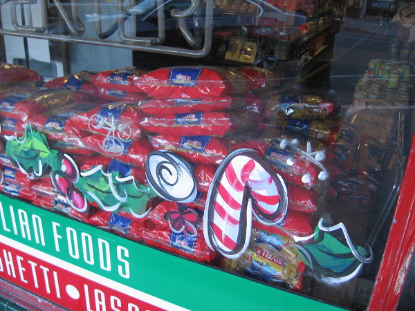Candy canes and pasta in a window of an Italian market. Perhaps it's a tasty combination, perhaps not.