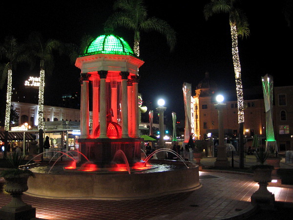The recently restored 1910 Broadway Fountain is lit with red and green light during the Christmas season at Horton Plaza Park in downtown San Diego.