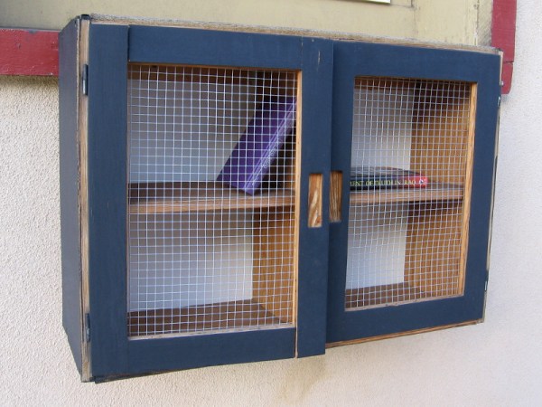 A lending library book box built like a cabinet along the Fifth Avenue sidewalk on Bankers Hill. The contents are always changing. Today the shelves were almost empty!