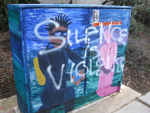 A guy in scuba gear seems to love a mermaid. The spray painted words Silence is Violence might have been applied later, or perhaps not.