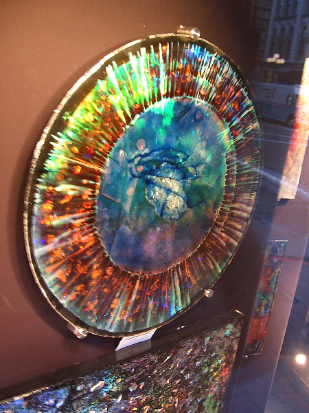 A shield-like work of holographic art seems to produce streams of light in this photo. But its actually reflections on the window from the nearby street.