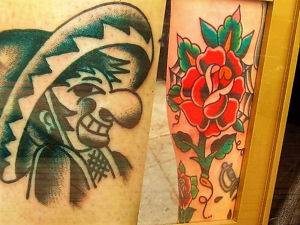 A flower blooms in the window of a downtown San Diego tattoo parlor.