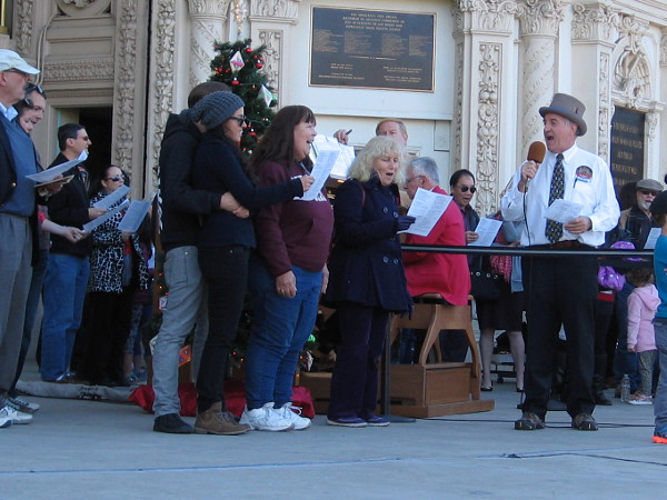 A small sample of humanity singing Christmas carols with joy.