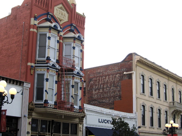 The building on the right is The McGurck Block, built in 1887. A drug store was located in it from 1903 to 1984. Actor Gregory Peck's father worked there as the night druggist.