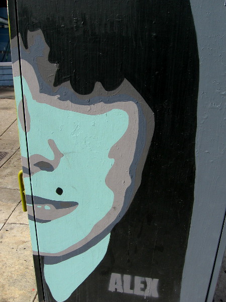 A blue face with a faint smile. Minimalist street art by Alex Avila.
