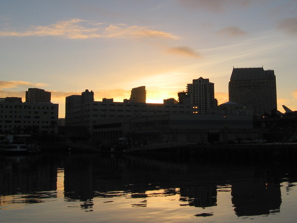 The sun is about to rise above a part of the San Diego skyline.