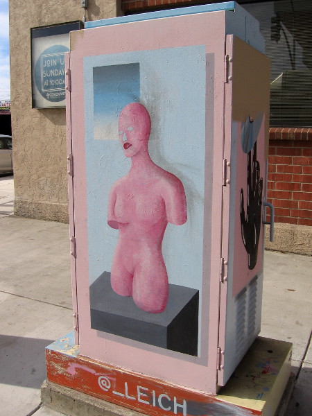 A bare pink face on a painted mannequin. Abstract street art in North Park.
