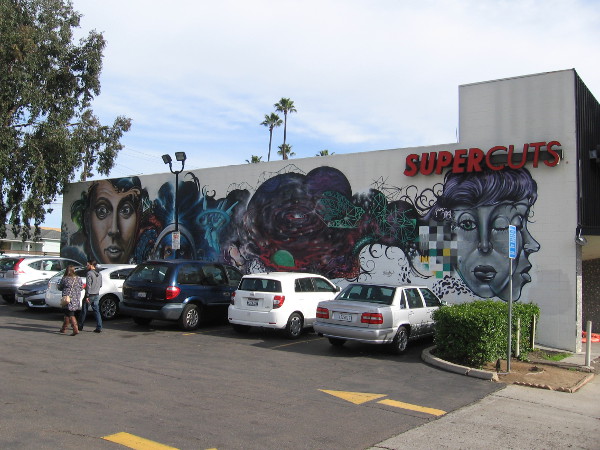 The mural on the Supercuts building contains many complex, colorful elements. Like a magnet it drew me in.