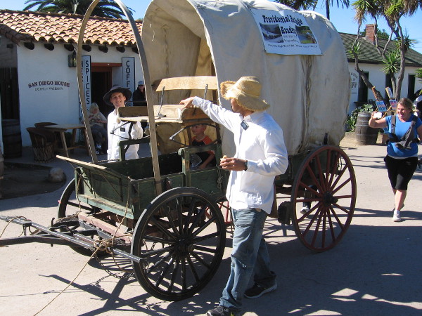 Folks enjoy taking a ride in an old-fashioned covered wagon in Old Town San DIego during 2017 Mormon Battalion Commemoration Day.