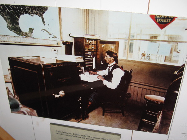 Agent William A. Biglow works in his express office which included an agent's cabinet and iron safe.