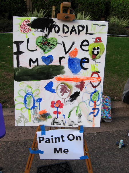 A canvas on El Prado asks random passersby to Paint On Me.