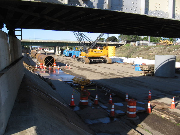 Passing under the train tracks as I walk along a raised area beside Friars Road.