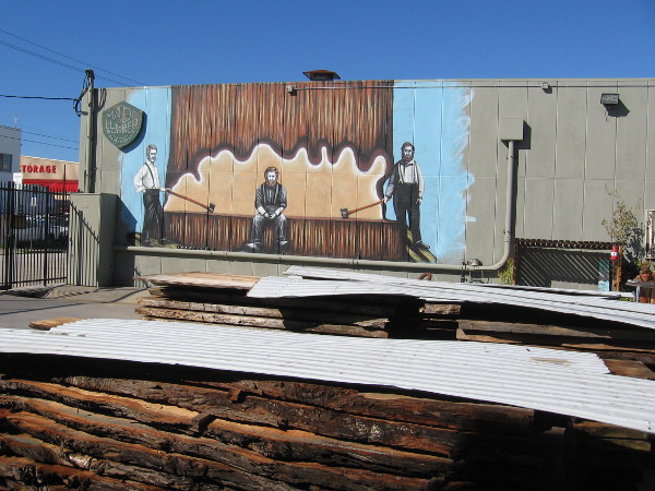 Another photo of the lumberjack mural, just beyond some real lumber!