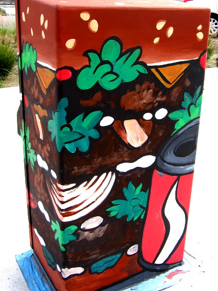 A creatively painted utility box near a National City street corner.