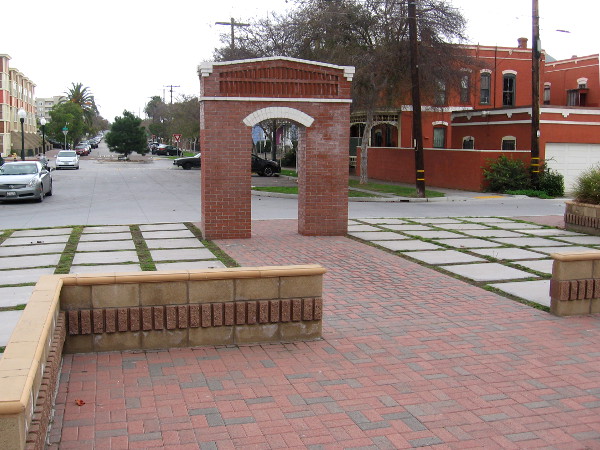 Visible beyond the brick arch is one end of Brick Row, one of several historic buildings in Heritage Square.