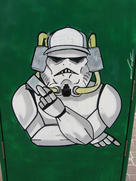 Poker Face Stormtrooper has beer hoses entering his helmet and a hand of cards.