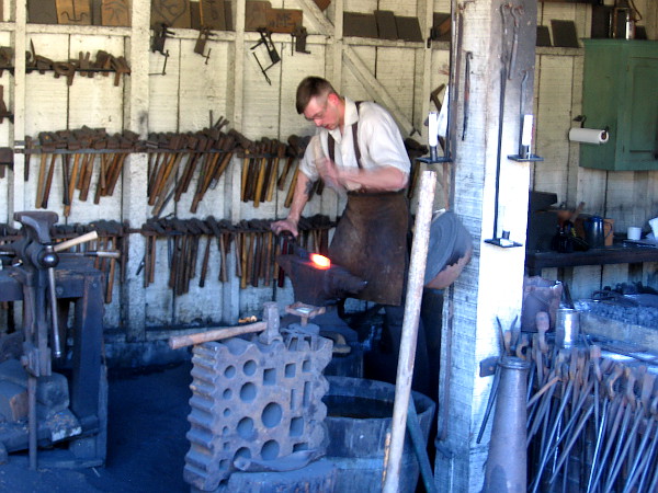 Shaping red hot iron in the old blacksmith shop.