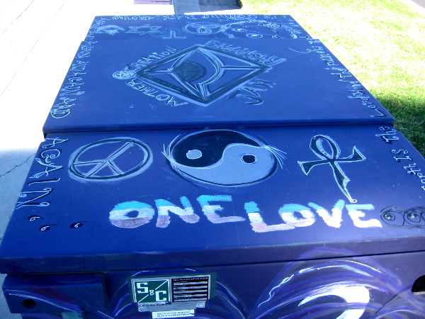 One Love and many symbols atop a utility box in Mira Mesa.