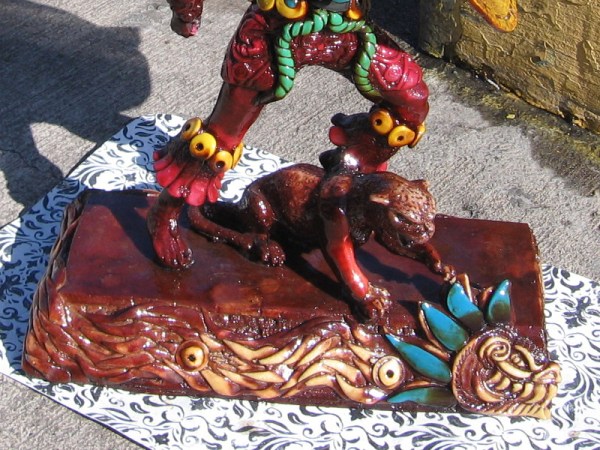 Close look at jaguar and serpent at foot of Aztec warrior, an amazing work of resin, acrylic and quartz by San Diego artist Carlos.