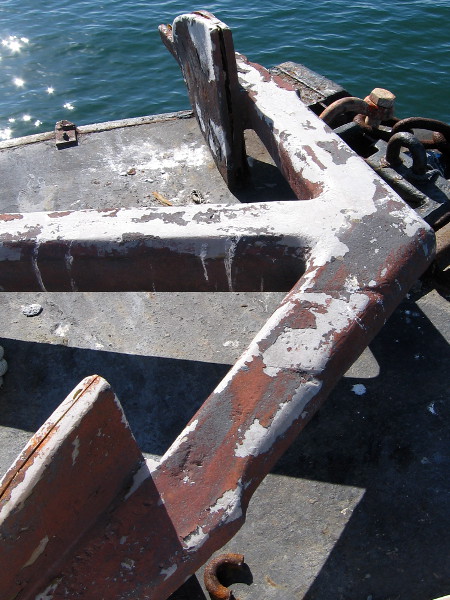 An anchor above calm water.