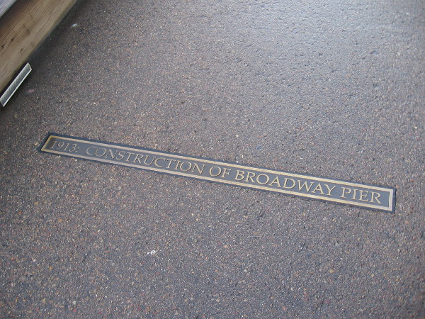 Bronze plaques create an historical timeline as one walks toward the pier's end. The construction of the Broadway Pier took place in 1913.