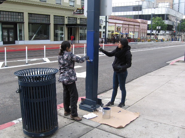 Volunteers in downtown San Diego add a coat of paint to a metal post. A wonderful community project put together by the Downtown San Diego Partnership.