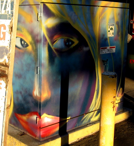 Spray painted face lit by sunshine early one morning, near Fourth Avenue and Robinson Avenue in Hillcrest.