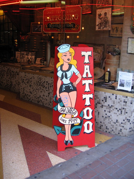 Navy pinup artwork on a tattoo parlor's entrance sign in the Gaslamp.