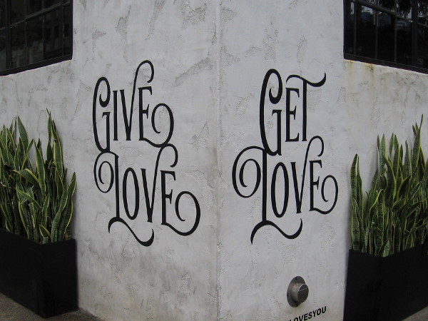 Wisdom on a corner of a downtown building. Give love. Get love.