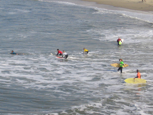 The surf competitors enter the water.