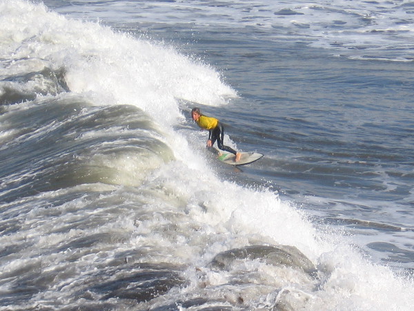 One of the surfers has caught a nice wave. The surf was very high today and made for some good rides.