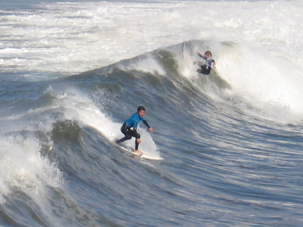 Two surfers tackle a good breaker!