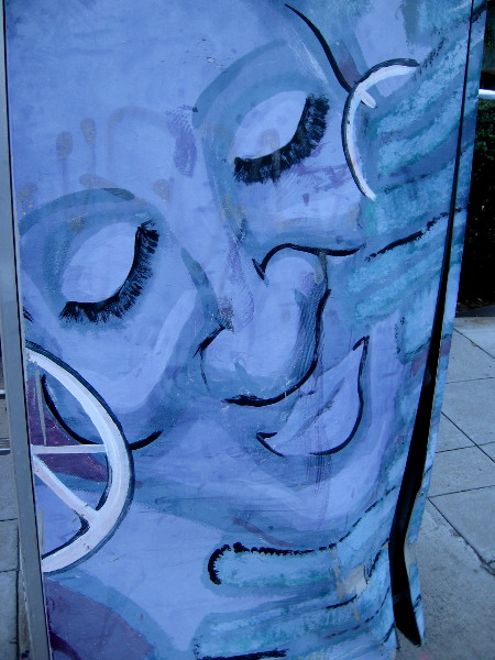 A contented face on a utility box near the intersection of Fourth Avenue and Laurel Street.