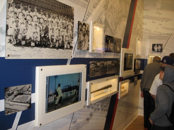 Padres fans check out lots of photos and cool artifacts which recall the history of baseball in San Diego. On the left are photos of the first Padres team in 1936, and Lane Field.