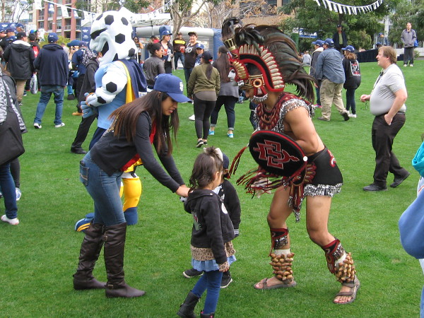 These kids seems a bit unimpressed by the Aztec Warrior, mascot of San Diego State University.