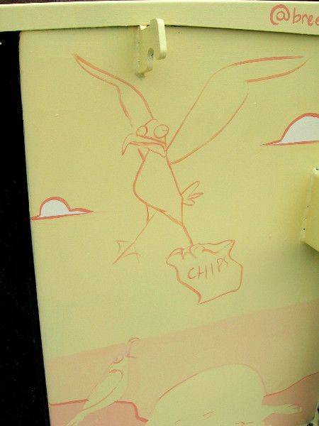 A funny sketch on an electrical box. A gull is carrying away a bag of chips!